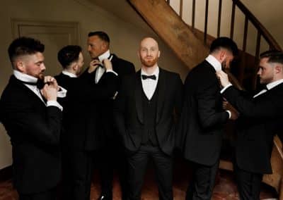 Groom and groomsmen getting ready for wedding ceremony