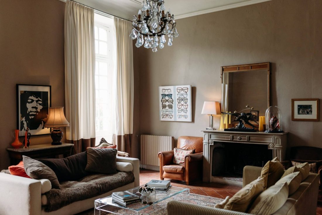 The clubroom at Chateau de Lartigolle with iconic Jimi Hendrix portrait and sofas you want to dive into